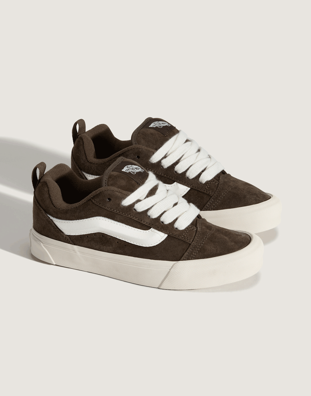 A pair of brown and black Knu Skool in a photography studio.