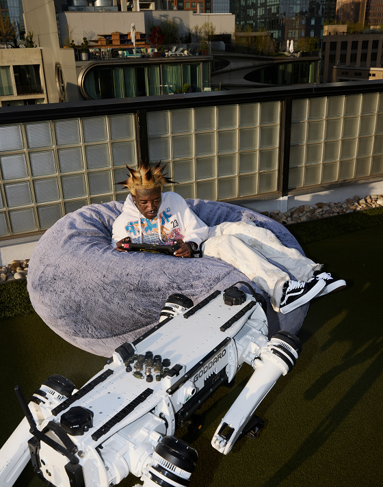 Lil Uzi Vert sitting in a beanbag chair wearing black old skool shoes.