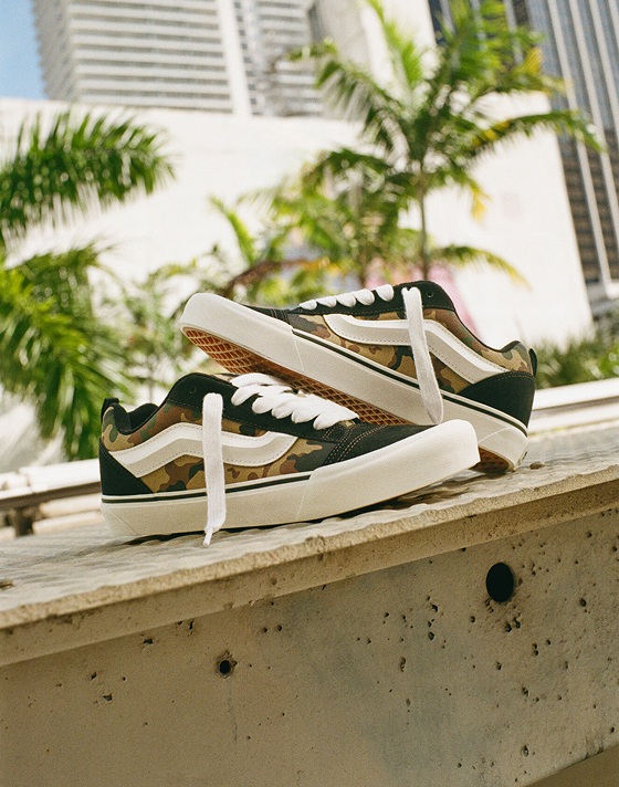 A pair of Camo Knu Skool like stacked on top of each other on the steps of a train station.