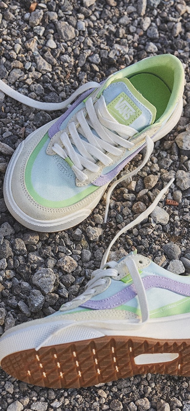 A pair of UltraRange 2.0 shoes laying on gravel. 