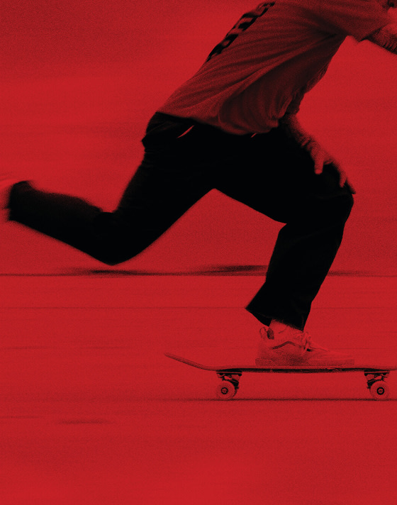 A red overlay on an image of someone pushing forward on their skateboard in Old Skool shoes.