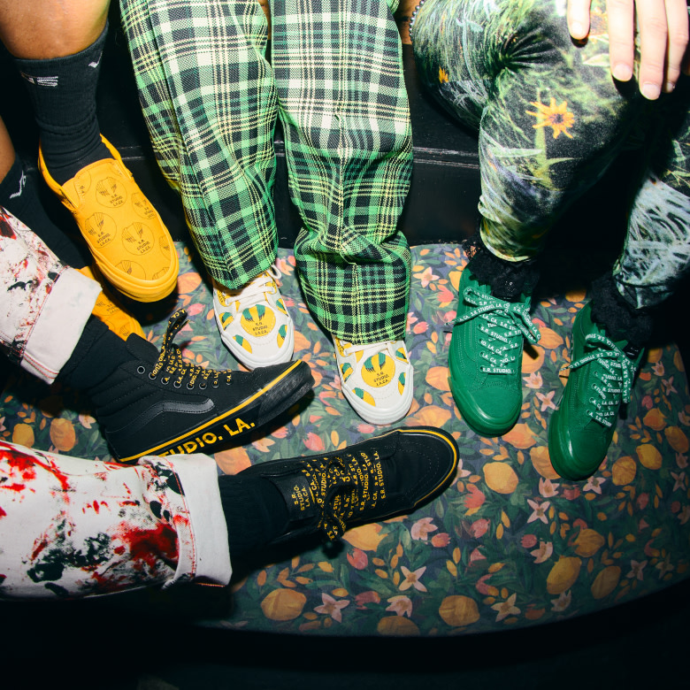OTW by Vans X Sterling Ruby shoes in black, white and green on a floral carpet.