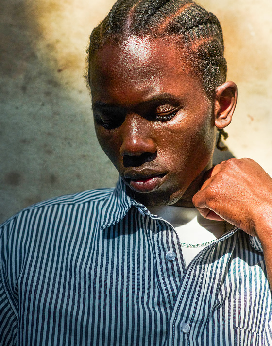 Close up of a man posing during golden hour in the Lawson Stripe Button Up Shirt.