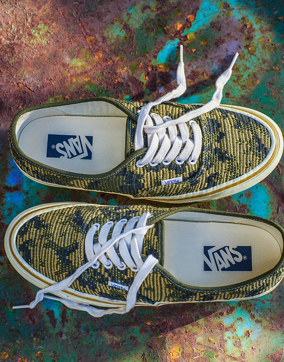 Close up shot of Vans Premium Authentic shoes in Antique Gold and Green color, against a colorful rust and graffiti background.