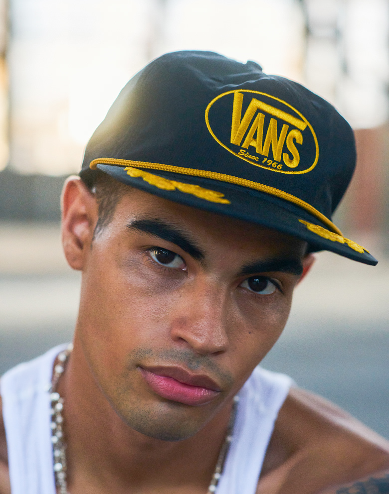 A young man wears a vans baseball cap