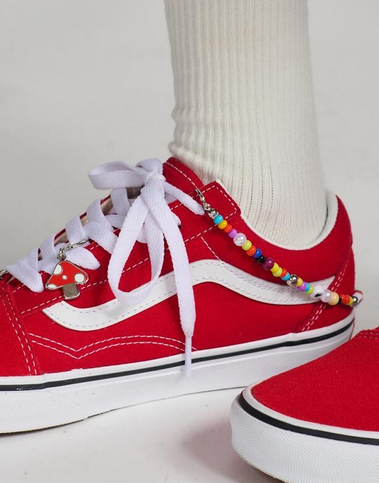 A close-up of shoe charms on vans old skool shoes.