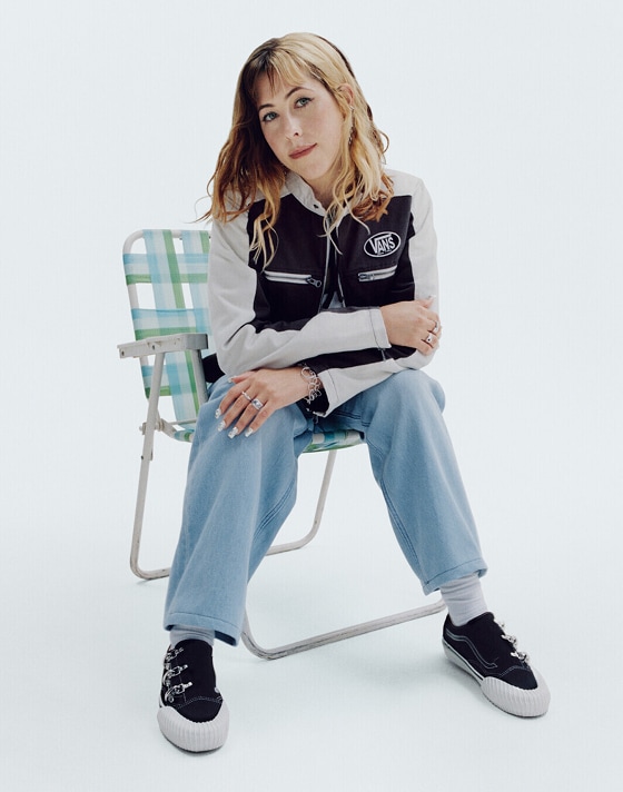 Lil Uzi Vert sitting in a beanbag chair wearing black old skool shoes.