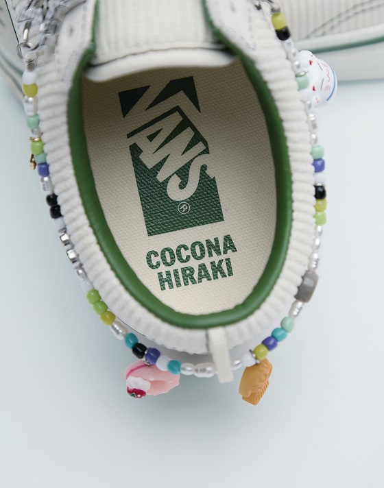 A close-up of the friendship bracelet on Cocona Hiraki’s white and green Premium Old Skool.