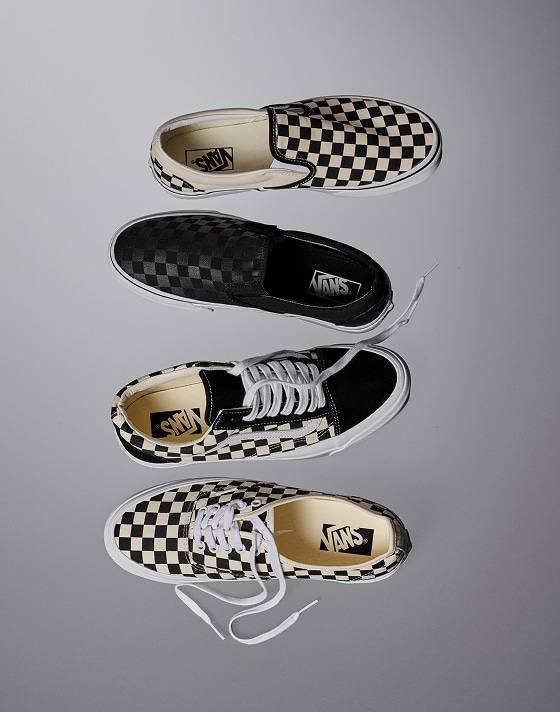 Vans Icons including the Authentic, Old Skool, and Classic Slip-On in off-white and black Checkerboard patterns in a photography studio.