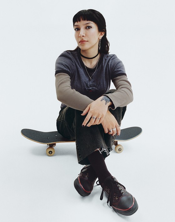 Vans Skater Tania Cruz holds up her Premium Old Skool in a photography studio with her name on the interior sole.