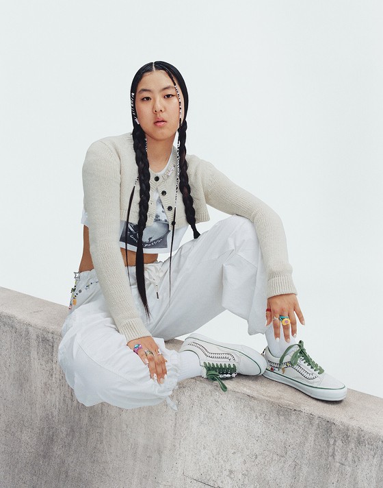Vans Skater Cocona Hiraki holds up her Premium Old Skool in a photography studio with her name on the interior sole.