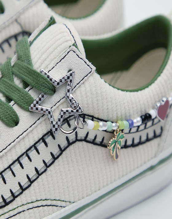 A close-up of the friendship bracelet on Cocona Hiraki’s white and green Premium Old Skool.