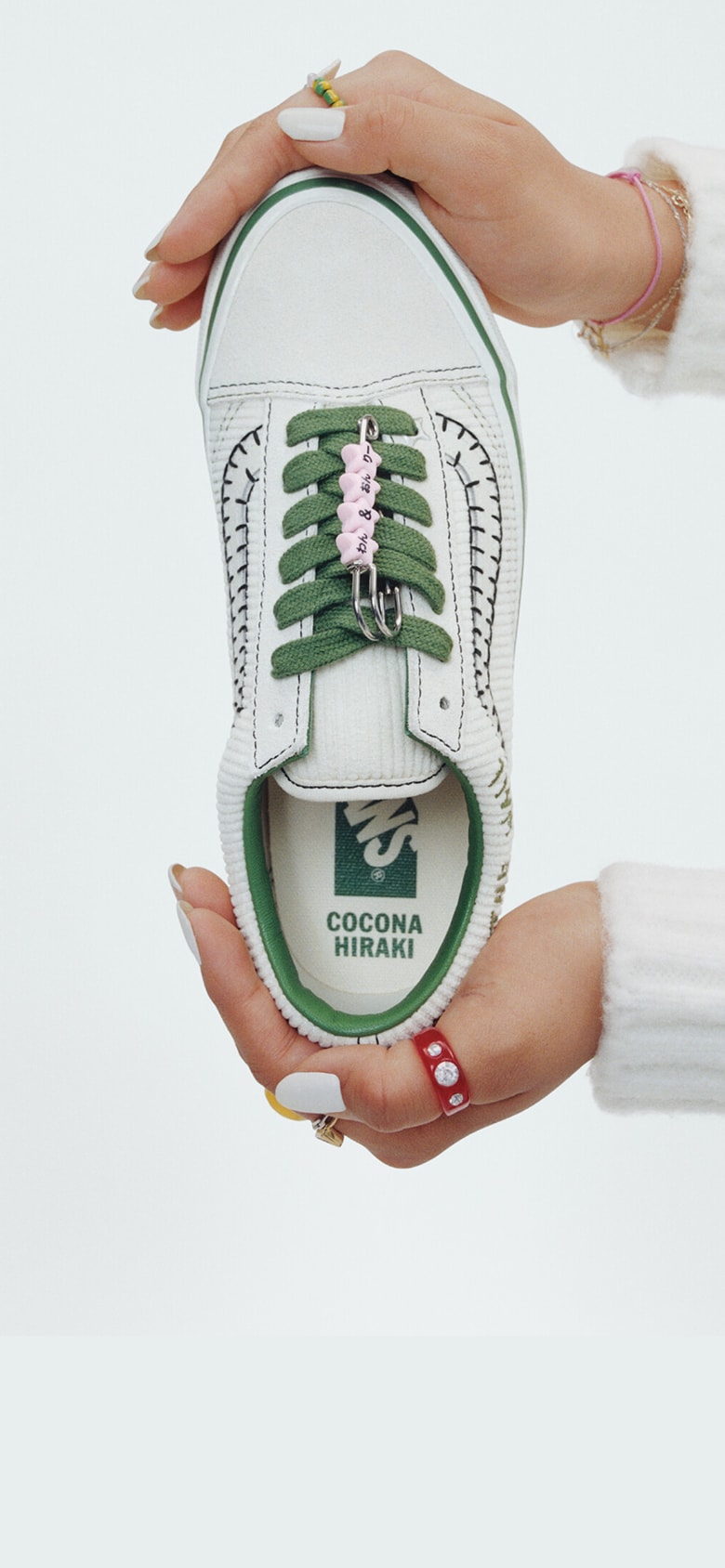 Vans Skater Cocona Hiraki holds up her Premium Old Skool in a photography studio with her name on the interior sole.