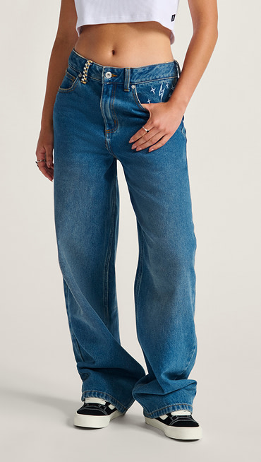 A waist-down shot of someone posing in blue Sirelle Embroidered Pants.