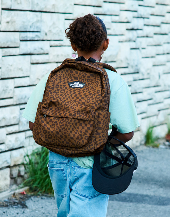 Close-up of a Dachsund Brown Old Skool Classic Backpack on a girl walking away from the camera.
