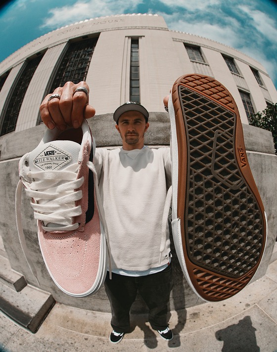 Vans Skate Team Rider Kyle Walker holding up his Kyle Walker Wafflecup skate shoes outside of a building.