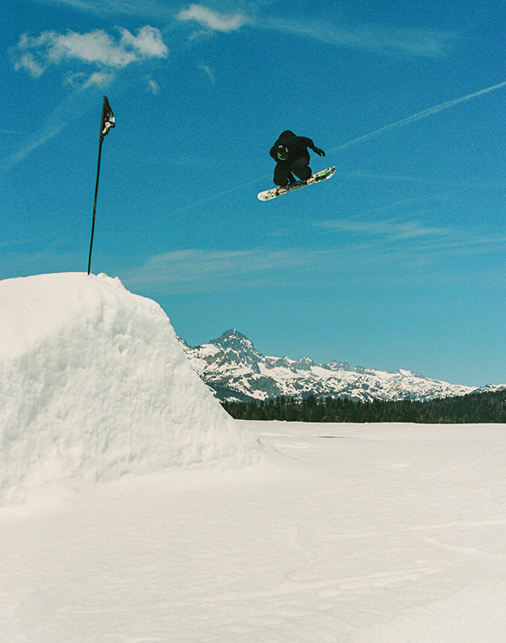 Vans Snowboard Team Rider Mia Brookes catching air and grabbing his board in the Encore Pro.