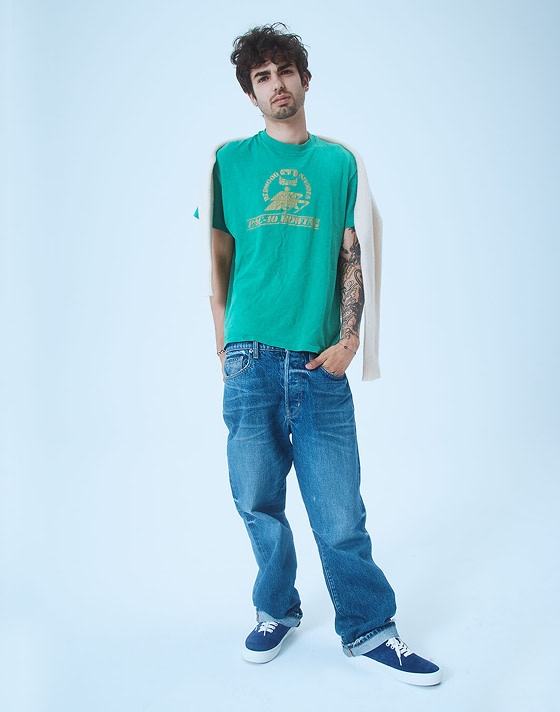 Pablo, a designer, poses in a photography studio wearing blue pig suede Premium Authentic on Open Set Los Angeles.