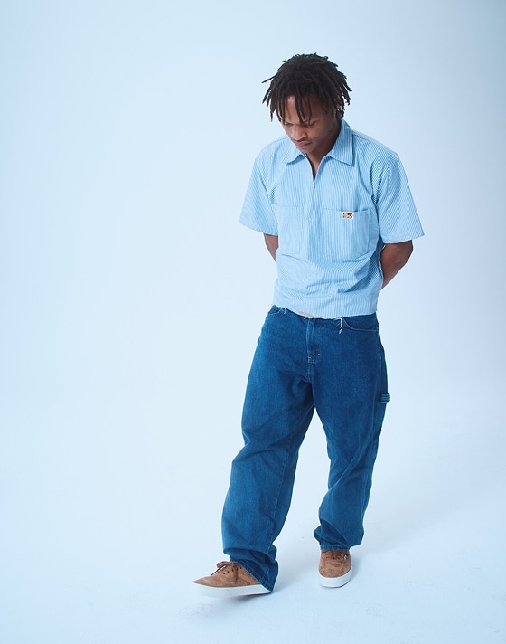 Hadrian, a skater, poses in a photography studio wearing pig suede Premium Authentic on Open Set Los Angeles.