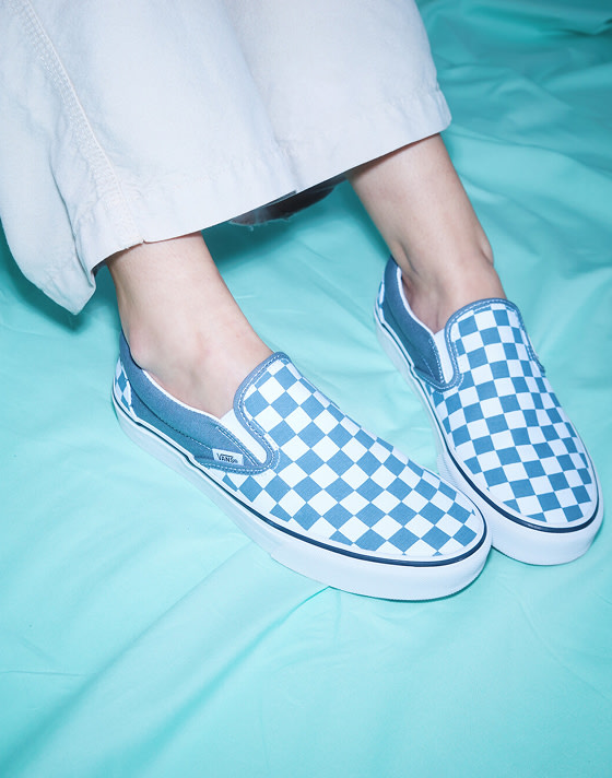 A close-up of director Gracie wearing stargazer blue Premium Classic Slip-On Checkerboard Shoe on the set of Open Set Los Angeles.
