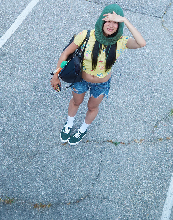 An overhead shot of model Justine wearing green pig suede Authentic in a parking lot on the set of Open Set Los Angeles.
