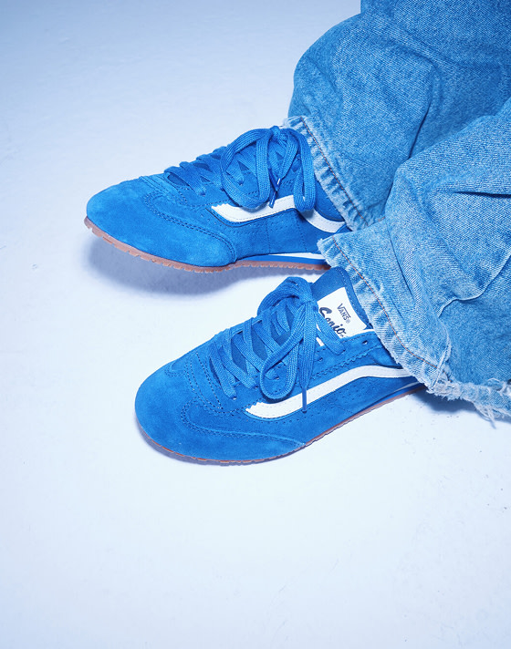 A close-up of designer Kat wearing blue Super Lowpro on the set of Open Set Los Angeles.