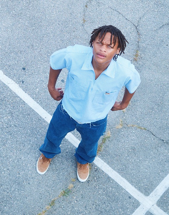 An overhead shot of skater Hadrian in a parking lot wearing pig suede Premium Authentic on the set of Open Set Los Angeles.