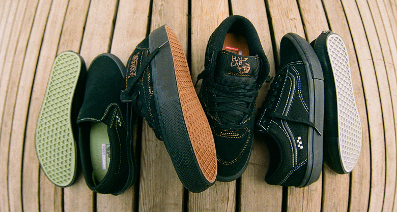 The all-black Skate Slip-On with green soles, the Skate Half Cab with brown soles, and the Skate Old Skool with gray soles lie on a wooden floor.