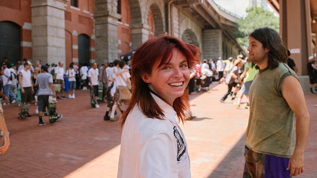 Professional skater Nelly Morville looks back at the camera heading into the Brooklyn Banks.