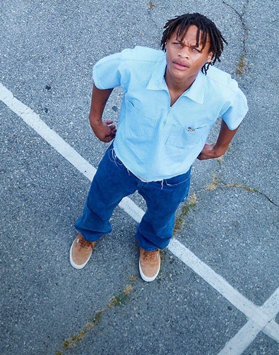 An overhead shot of skater Hadrian in a parking lot wearing pig suede Premium Authentic on the set of Open Set Los Angeles.
