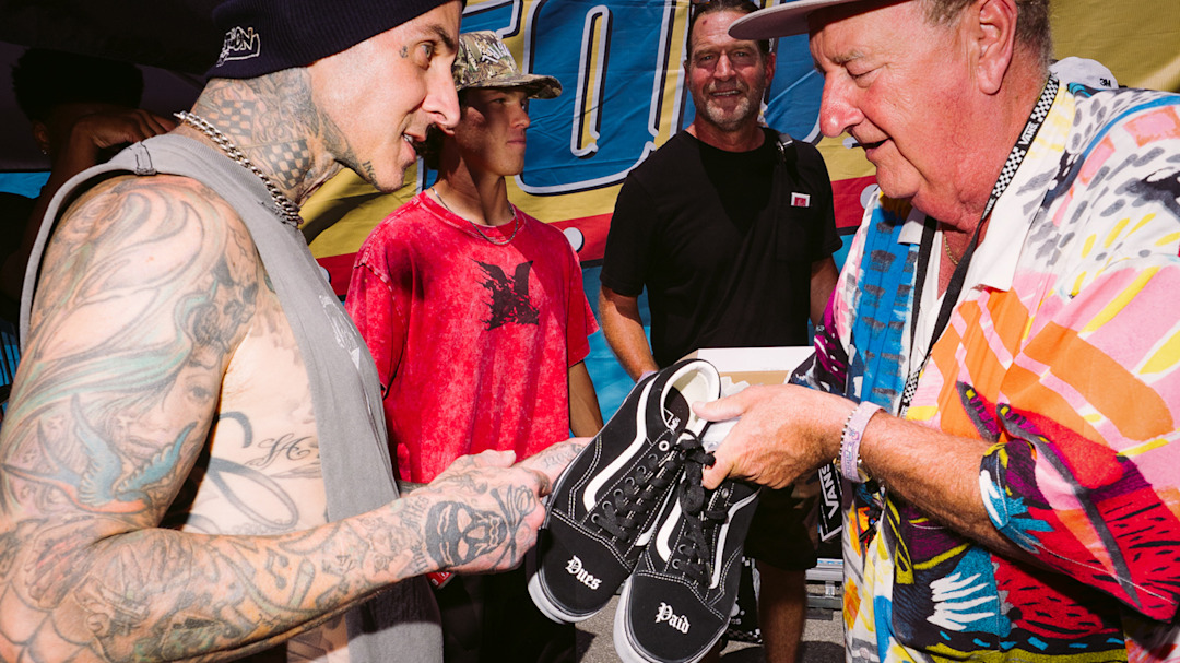 Steve Van Doren handing Travis Barker a pair of Vans at Vans Warped Tour.