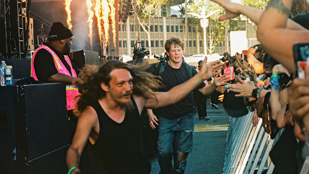 Vans Warped Tour crowd members running back out to the crowd after crowd surfing.