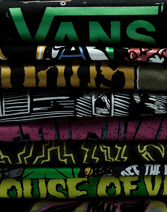 A selection of Vans Halloween t-shirts stacked on top of each other.