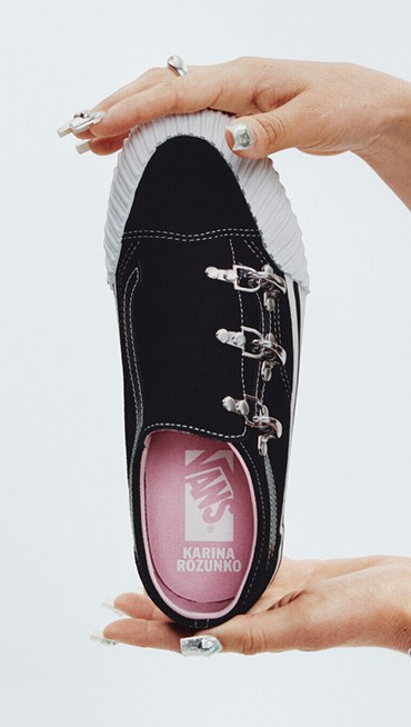 Vans Surfer Karina Rozunuko holds up her Premium Old Skool in a photography studio with her name on the interior sole.