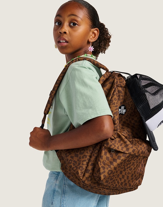 A young girl looks over her shoulder wearing a Dachshund Brown Old Skool Classic Backpack.