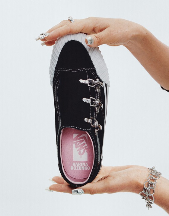 Vans Surfer Karina Rozunuko holds up her Premium Old Skool in a photography studio with her name on the interior sole.