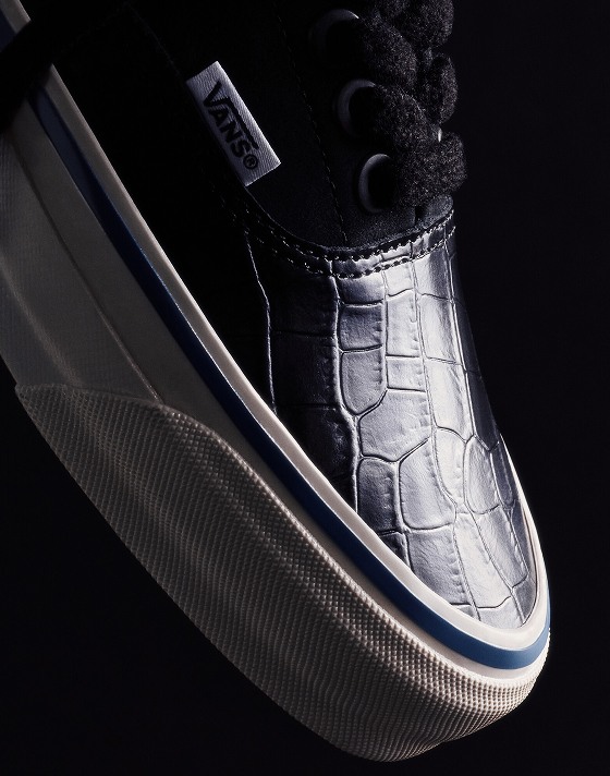 The Era 95 with a crocodile leather pattern from OTW floats in the air against a black background.