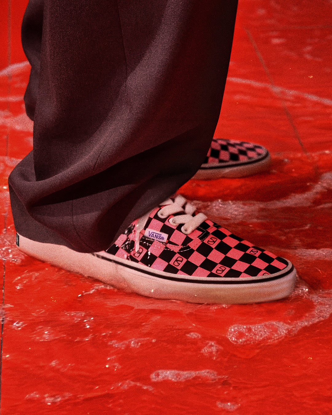 Pink Valentino and Vans Authentic on a flooded floor.