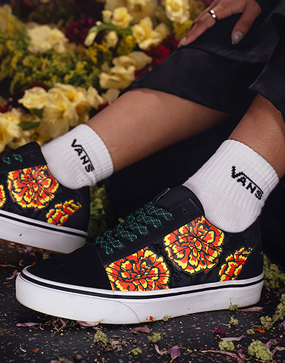 A close-up on the marigold prints on the Old Skool for Día de Muertos paired with white Vans socks.