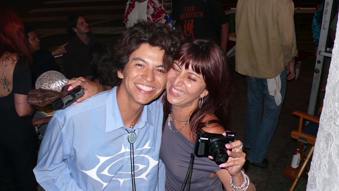 Lola laughing with a friend at her film premiere.