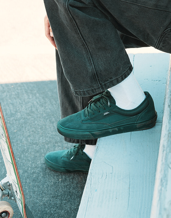 A knee-down shot of someone wearing the Curren from the United Through Skateboarding collection.