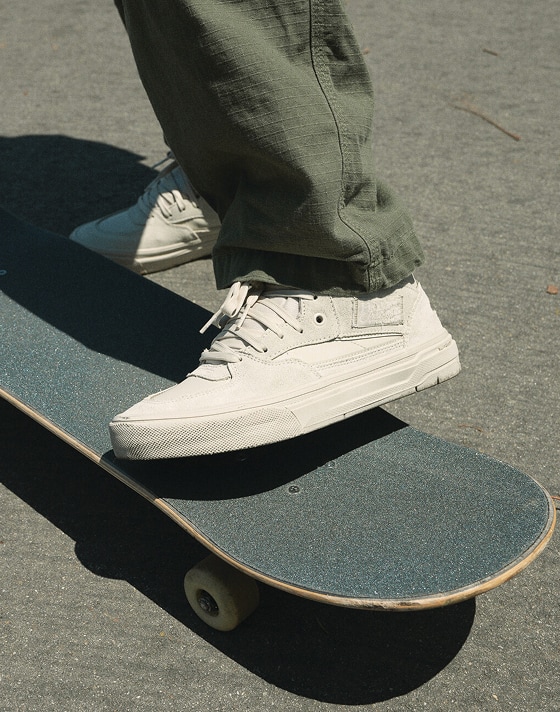 A close-up of the white Skate Half Cab Wafflecup on a skateboard from the United Through Skateboarding collection.