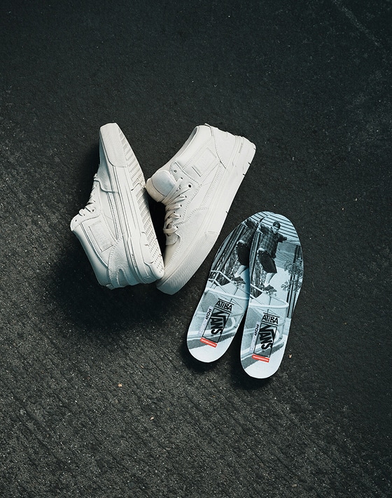 An overhead shot of the white Half Cab Wafflecup and its soles from the United Through Skateboarding collection.