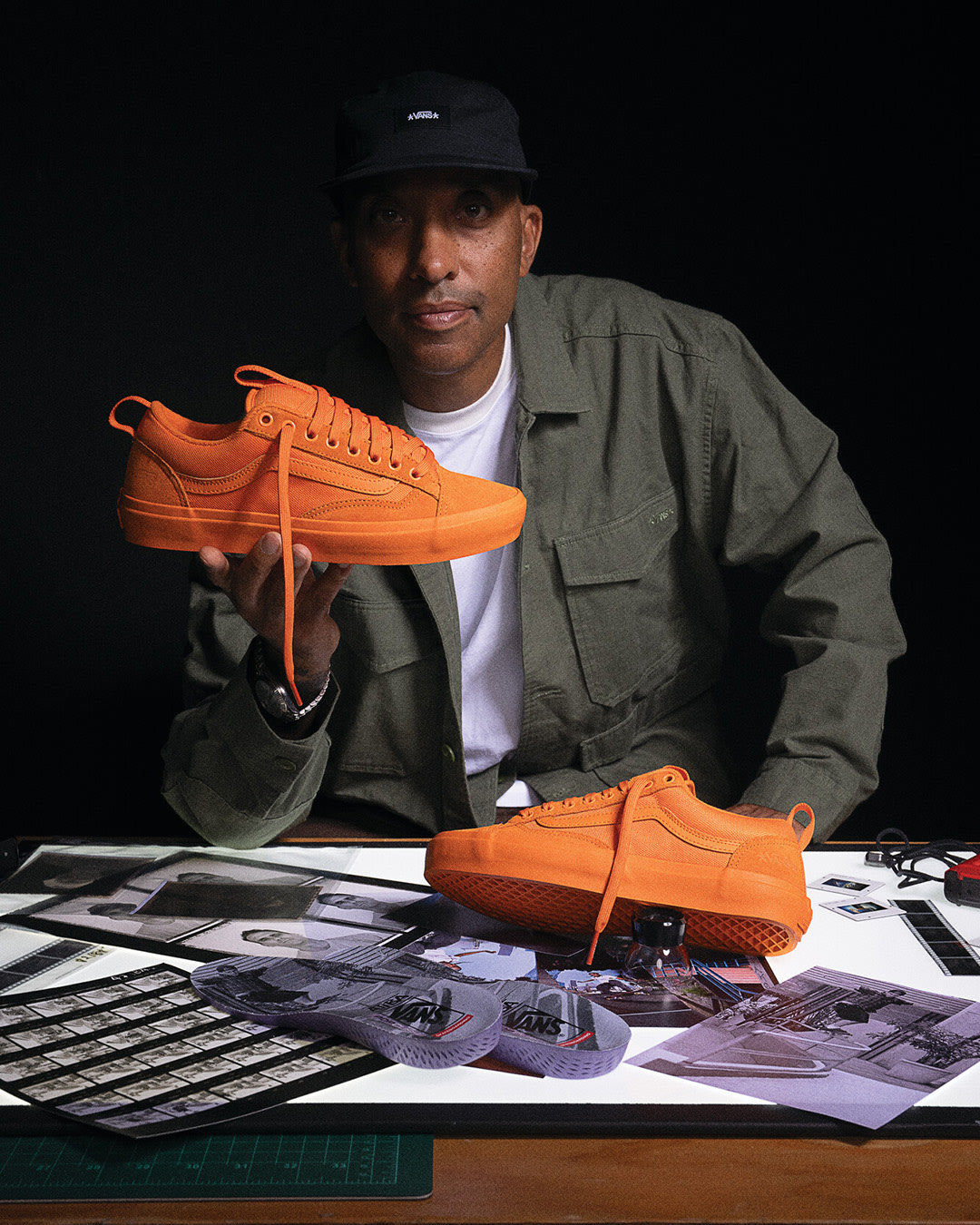 Atiba Jefferson holding up his orange Vans X Atiba Old Skool 36+ shoe