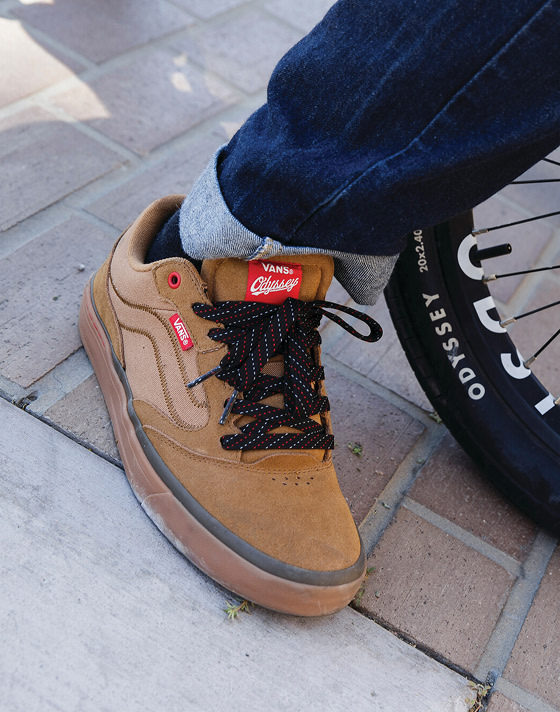 A close-up of the brown Vans x Odyssey BMX Proof WaffleCup paired with blue jeans.