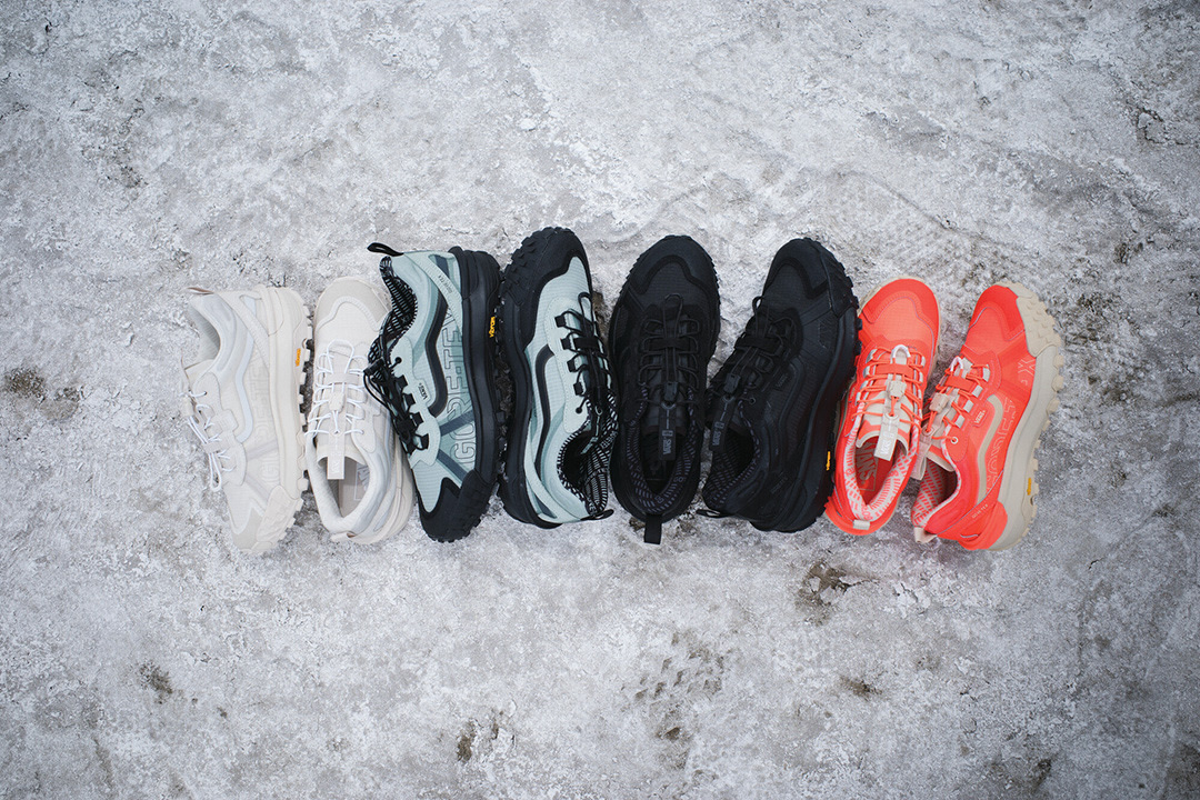 Four pairs of Crosspath XC GORE-TEX Shoes - white, blue, black and orange - sitting on an icy surface.