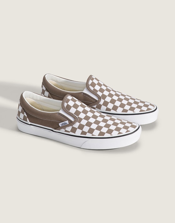 A pair of cream and white Classic Slip-On in a photography studio.