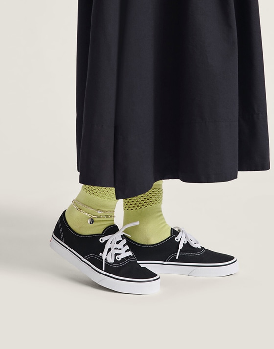 A waist-down shot of a woman wearing the black Francesca full skirt with black Authentic.