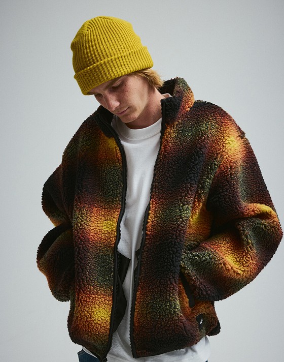 A man wearing a High Pile Jacket in a photography studio.