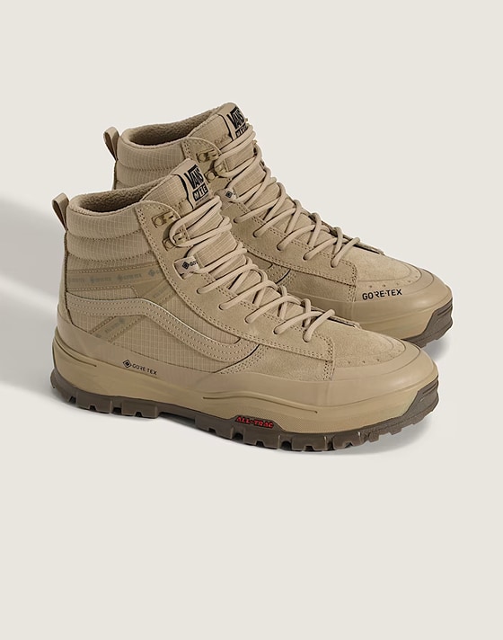 A pair of brown Sk8-Hi GORE-TEX in a photography studio.